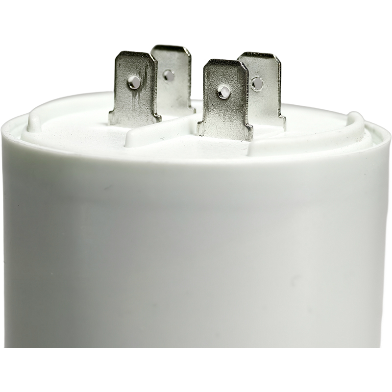 How does the self-healing property of ac motor capacitors extend their service life?
